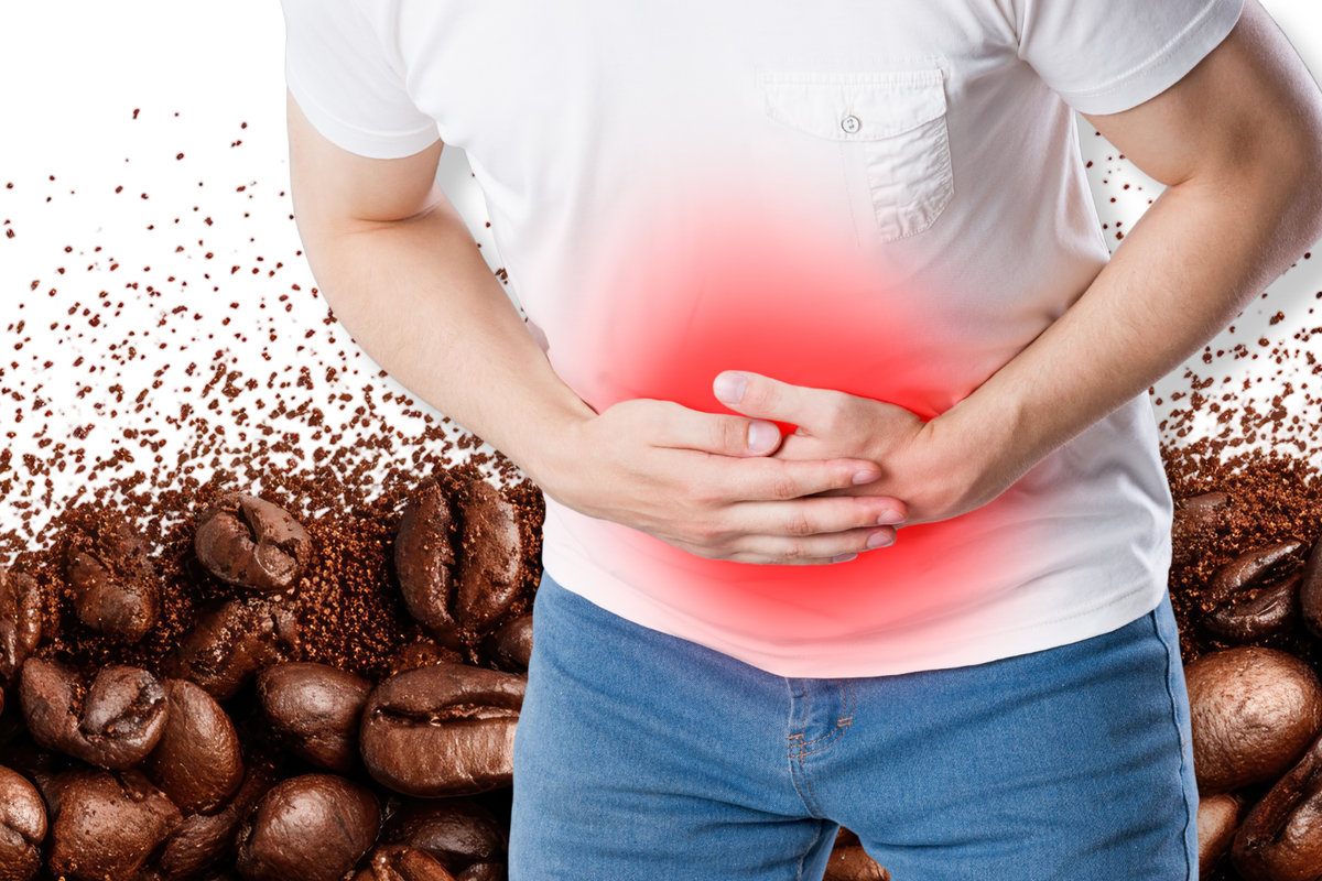 Person holding stomach in pain from caffeine