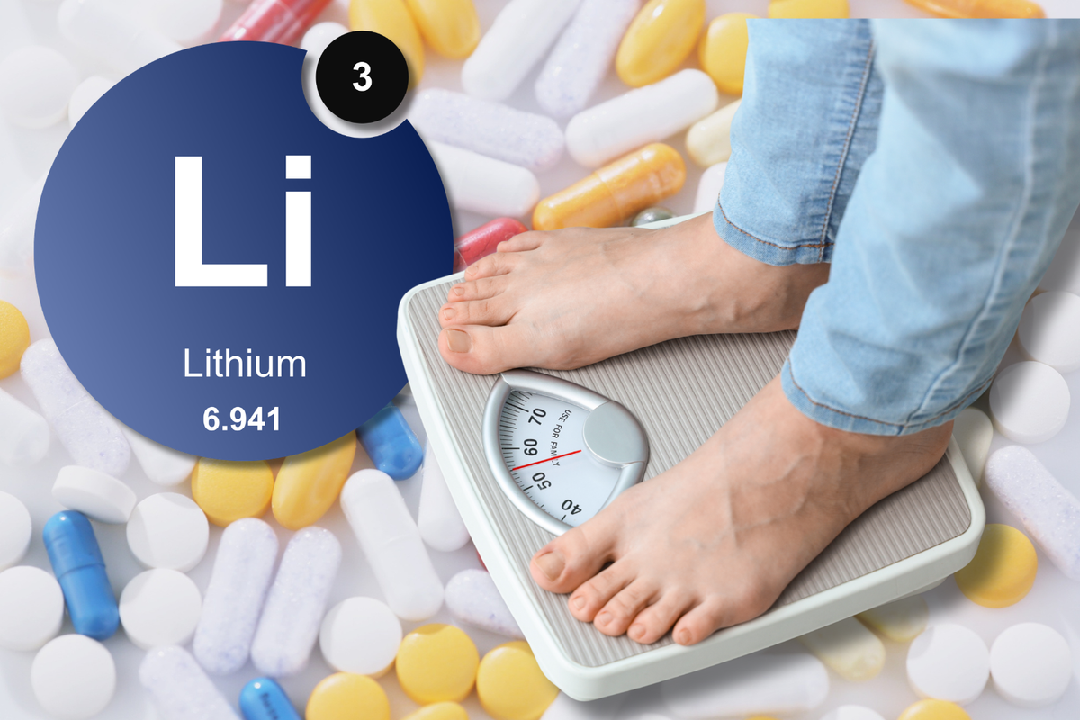 Person standing on a scale beside a lithium symbol and pills, illustrating the question of whether lithium can cause weight gain.