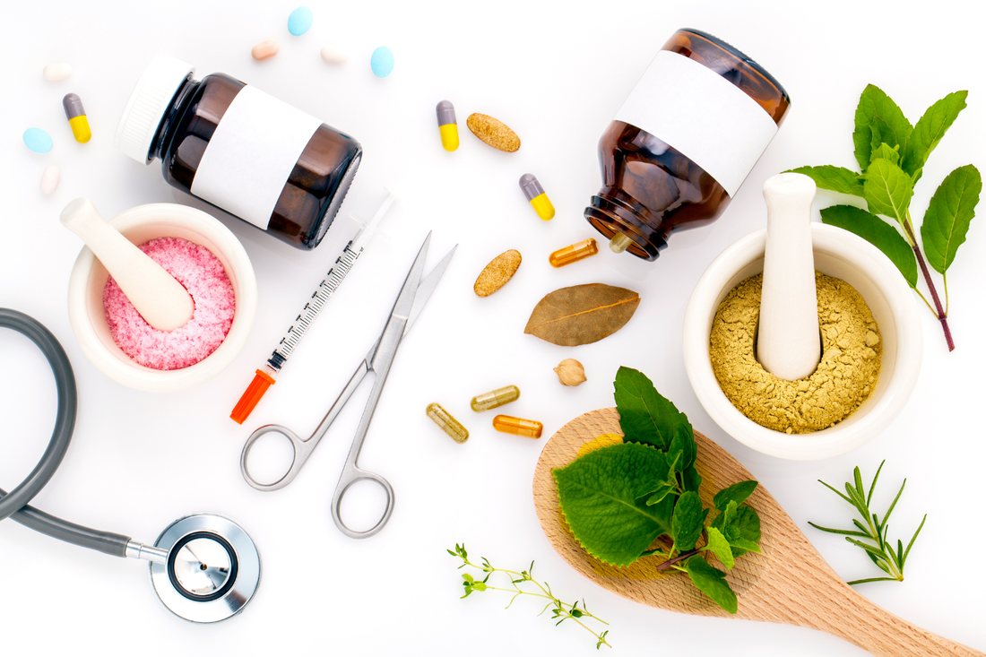  Supplements, herbs, a stethoscope, and medical tools arranged on a white background